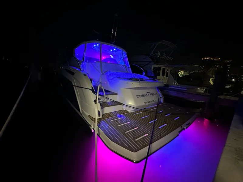 Slide: The Image of Azimut Atlantis 45 yacht, 2021 model, illuminated with vibrant blue and pink lights at night. - 40