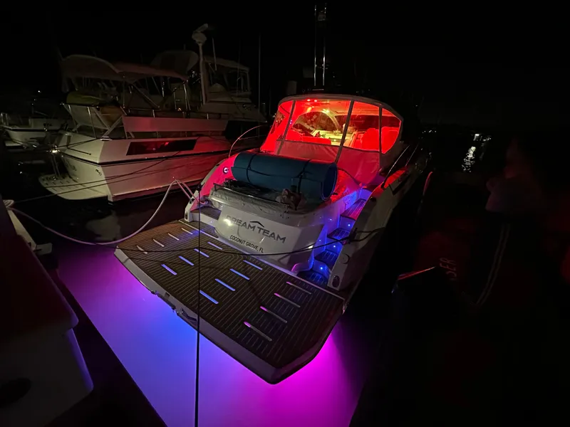 Slide: The Image of 2021 Azimut Atlantis 45 yacht with vibrant red and blue lights at night. - 41