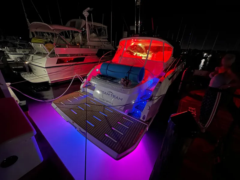 Slide: The Image of Azimut Atlantis 45 yacht, 2021 model, illuminated with vibrant red and blue lights at night. - 42
