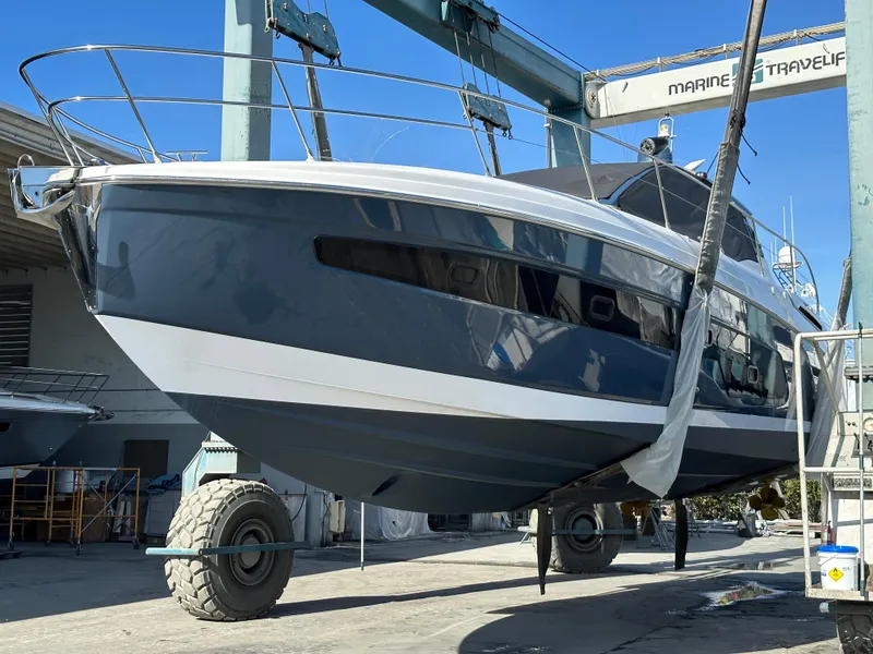 Slide: The Image of Azimut Atlantis 45 yacht, 2021 model, in dry dock for maintenance under clear blue sky. - 44