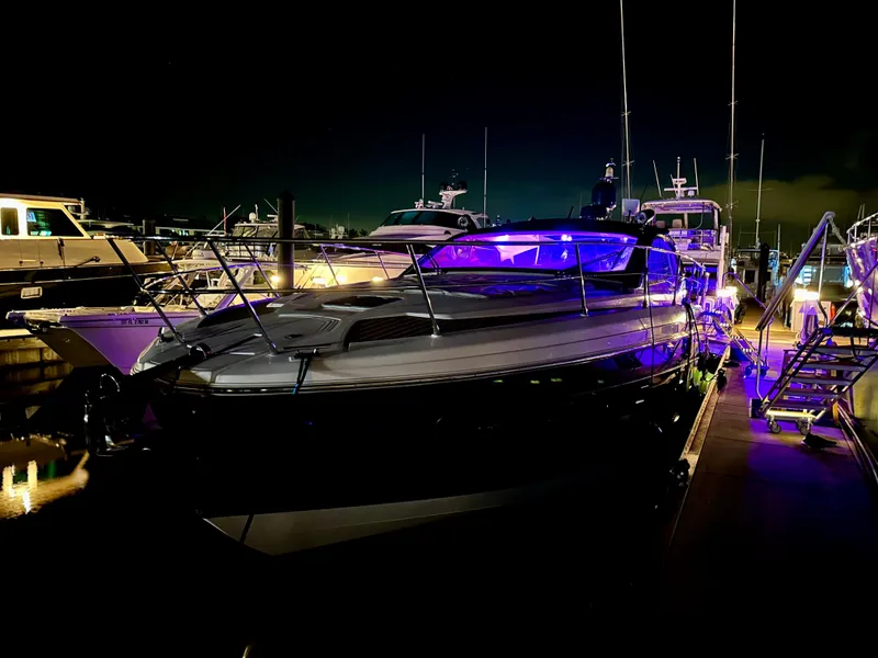 Slide: The Image of 2021 Azimut Atlantis 45 yacht docked at night with vibrant blue lighting. - 6