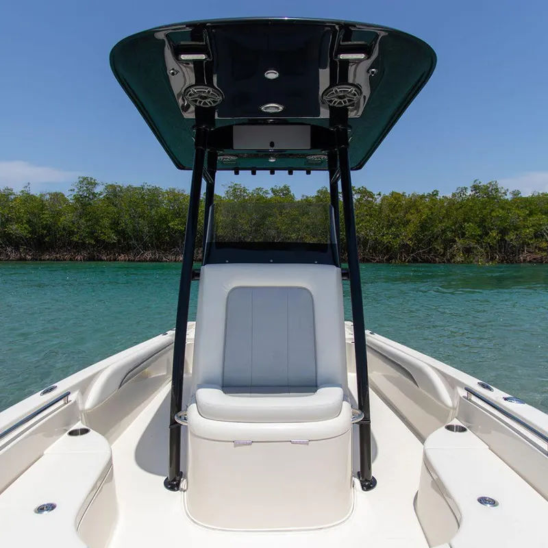 Slide: The Image of 2023 ShearWater 250 XTE boat with sleek seating and canopy on calm water. - 10