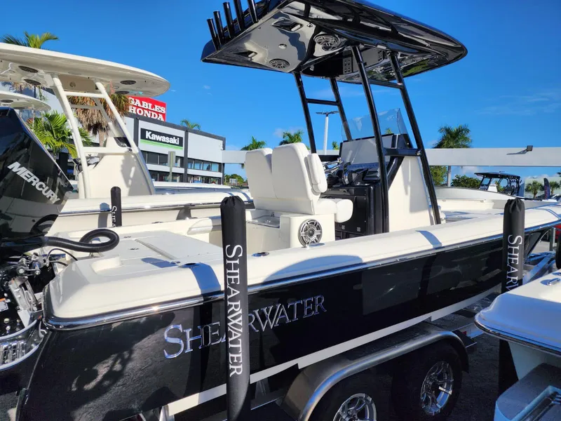 Slide: The Image of 2023 ShearWater 250 XTE boat displayed at a dealership. - 2