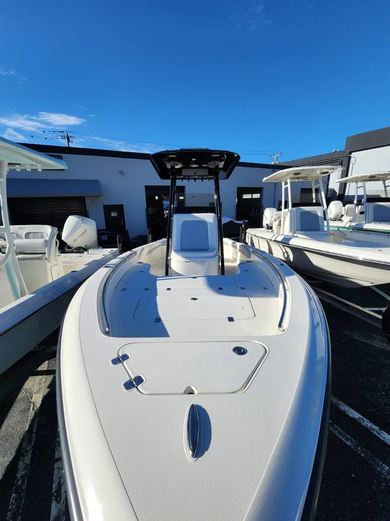 Slide: The Image of 2023 ShearWater 250 XTE boat with sleek design, docked under clear blue sky. - 5
