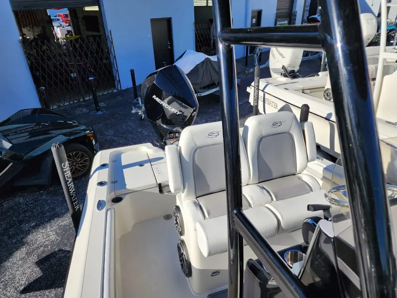 Slide: The Image of 2023 ShearWater 250 XTE boat interior with seating and motor. - 7