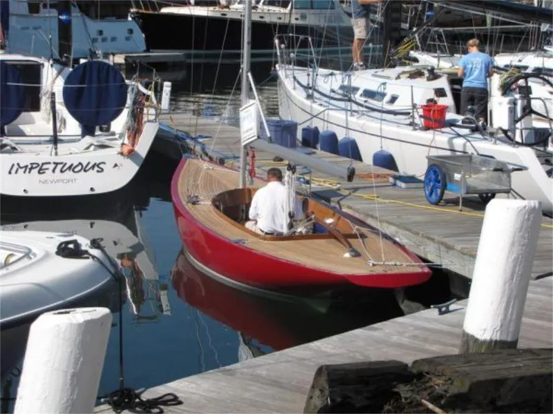 Slide: The Image of 2025 Rustler 24 sailboat docked at a marina, surrounded by other boats. - 12