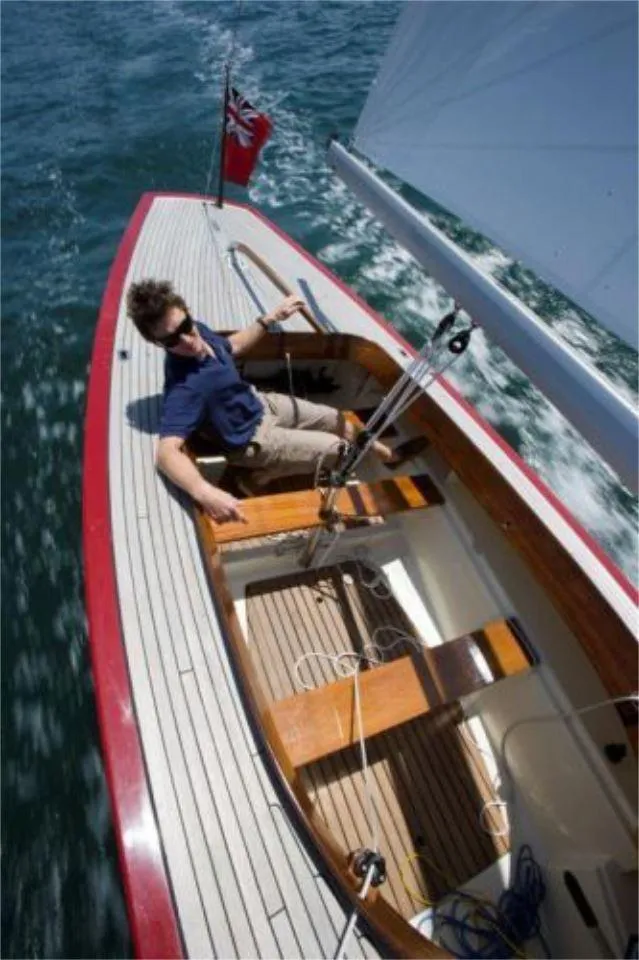 Slide: The Image of Person sailing a 2025 Rustler 24 yacht on open water. - 15