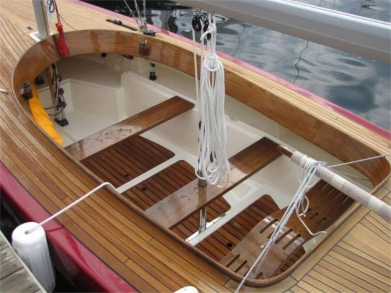 Slide: The Image of Rustler 24 sailboat cockpit, 2025 model, featuring elegant wooden deck and seating. - 16