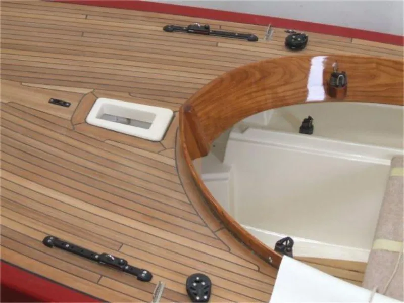 Slide: The Image of 2025 Rustler 24 sailboat deck with polished wood finish and sleek design. - 17