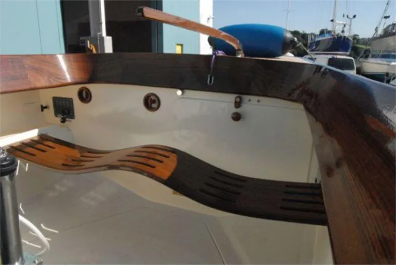 Slide: The Image of Interior view of 2025 Rustler 24 sailboat with wooden trim and seating. - 18