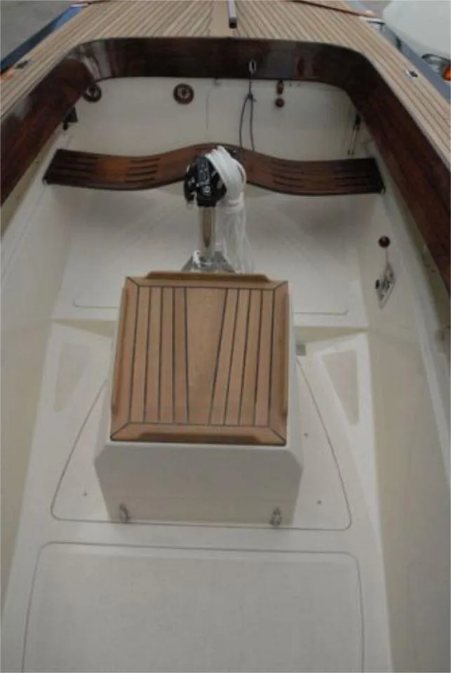 Slide: The Image of 2025 Rustler 24 boat interior with wooden accents and steering mechanism. - 19