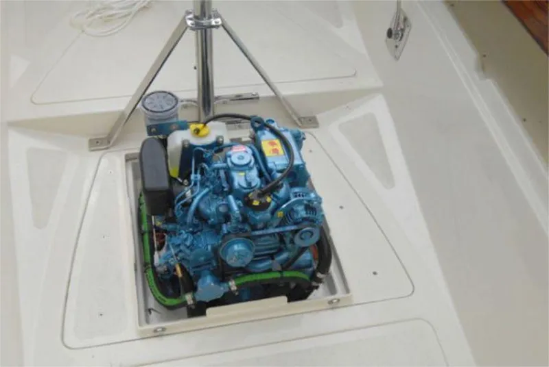 Slide: The Image of Engine compartment of 2025 Rustler 24 sailboat, showcasing a compact blue engine. - 21