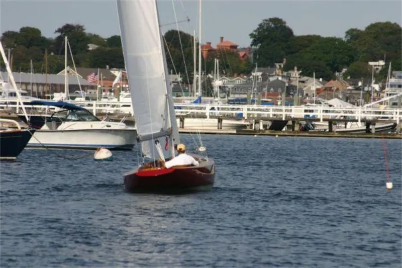 Slide: The Image of Sailboat Rustler 24 (2025) navigating a marina with other boats and waterfront buildings. - 6