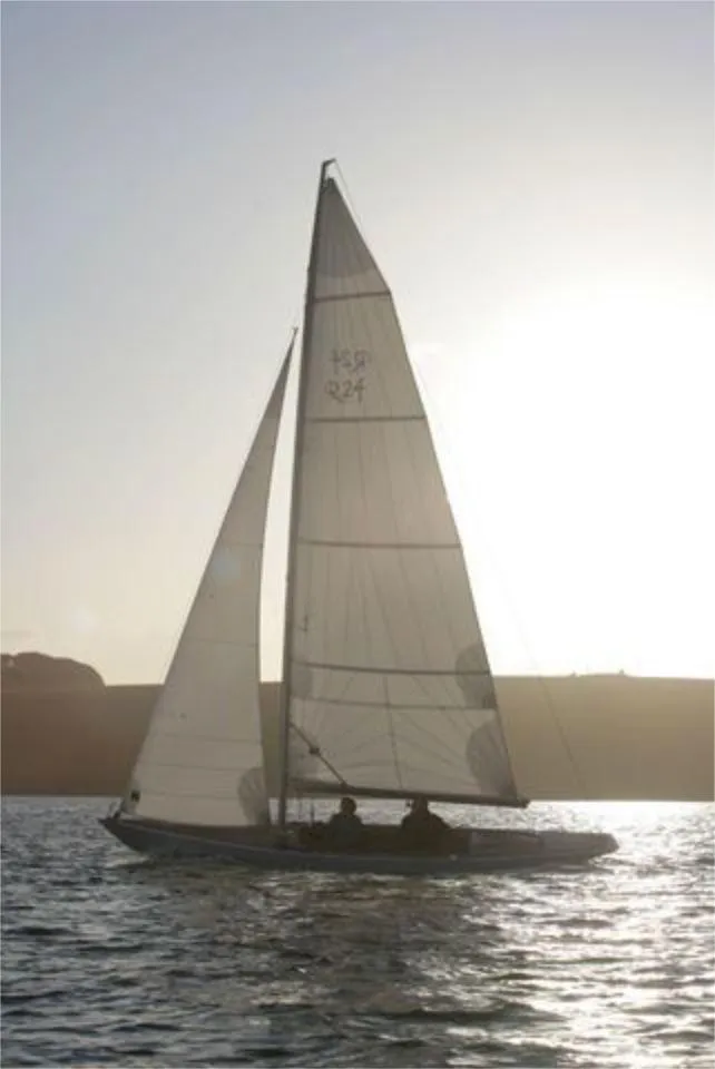 Slide: The Image of Sailboat Rustler 24, 2025 model, sailing at sunset on calm waters. - 9