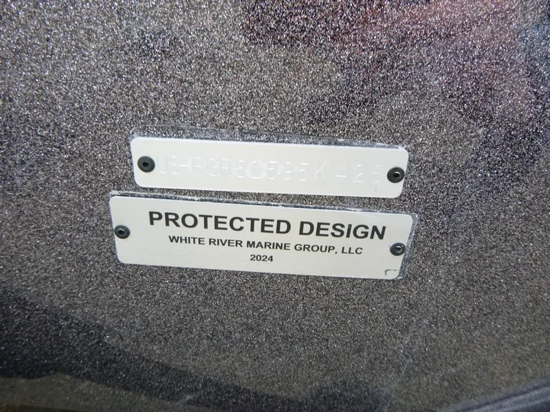 Slide: The Image of 2025 Ranger Z521 boat storage compartment with textured flooring and open hatch. - 16