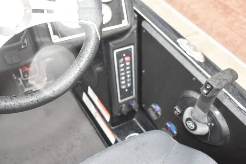 Slide: The Image of 2025 Ranger Z521 boat cockpit with steering wheel and control panel, featuring modern design elements. - 17