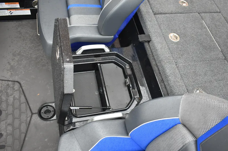 Slide: The Image of 2025 Ranger Z521 boat interior with open storage compartment and blue-gray seating. - 20
