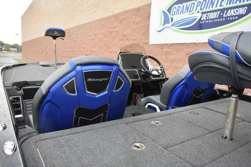 Slide: The Image of 2025 Ranger Z521 boat interior with blue seats at Grand Pointe Marina. - 3