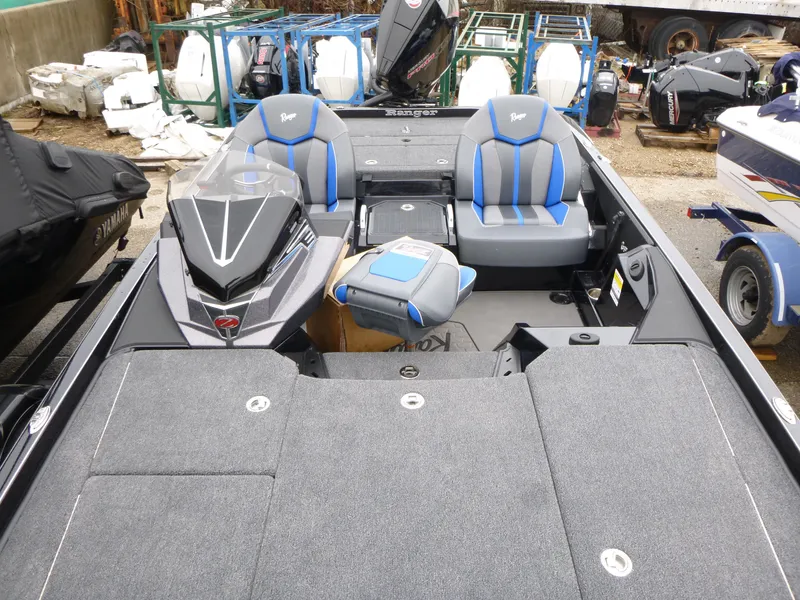 Slide: The Image of 2025 Ranger Z521 boat battery compartment with wiring and storage. - 9
