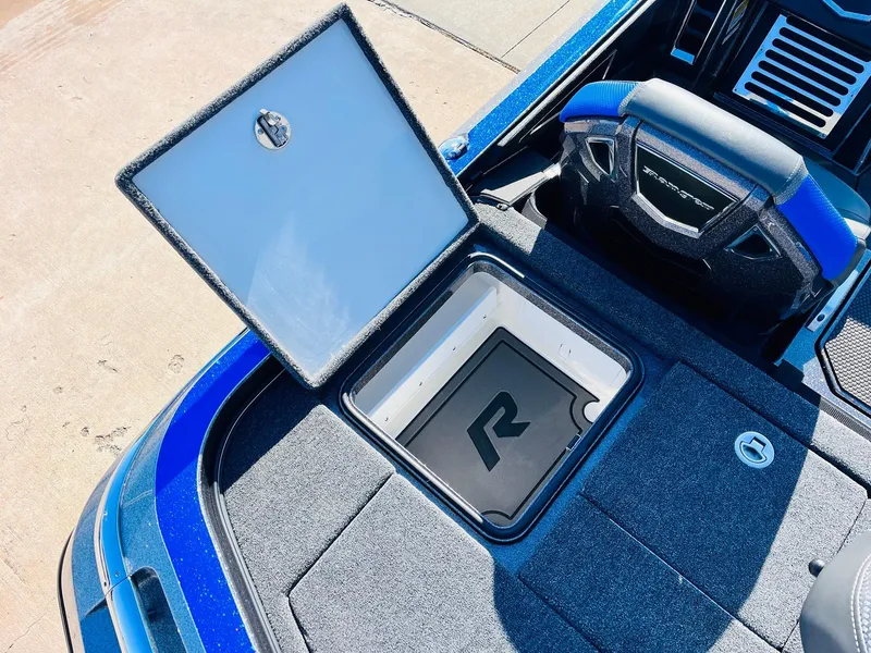 Slide: The Image of 2025 Ranger Z520R Cup-Equipped boat storage compartment, open lid, blue interior. - 43