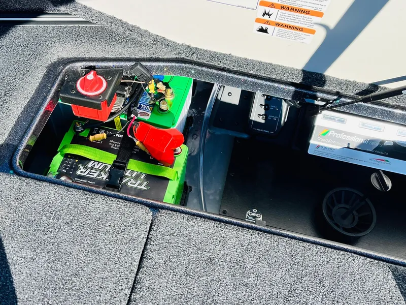 Slide: The Image of 2025 Ranger Z520R Cup-Equipped boat battery compartment with green batteries and wiring. - 49