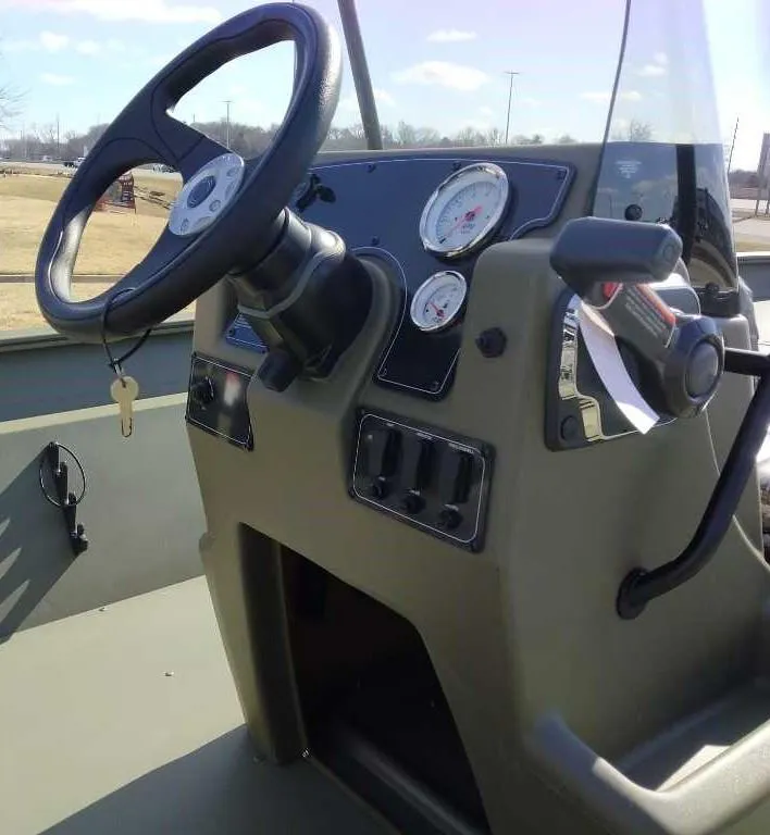 Slide: The Image of 2025 Tracker Grizzly 2072 CC boat console with steering wheel and gauges. - 4