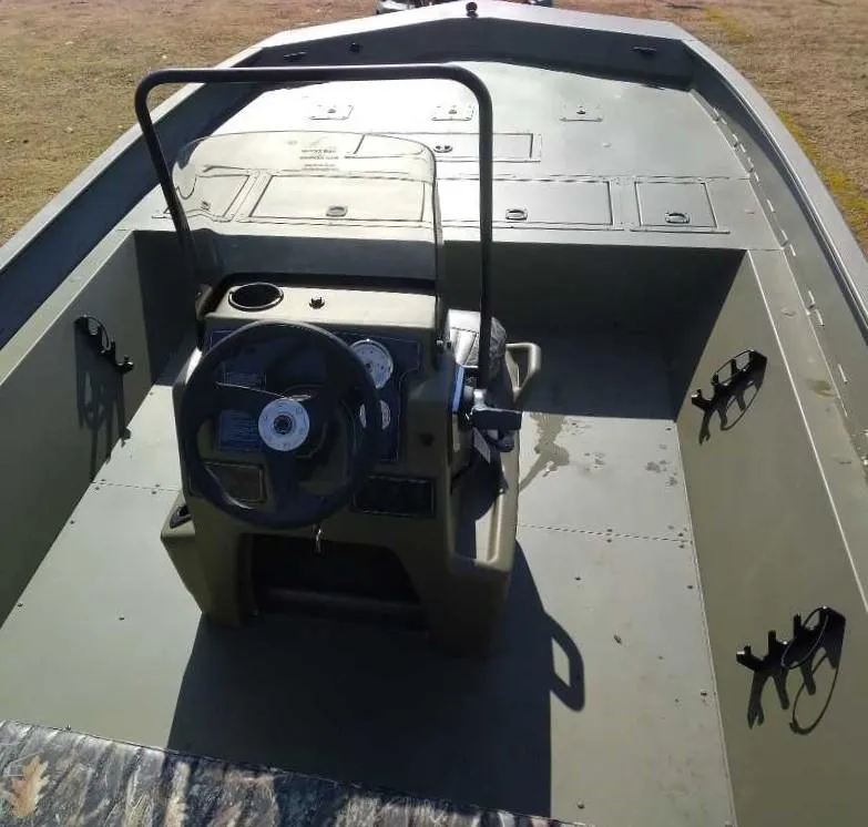 Slide: The Image of 2025 Tracker Grizzly 2072 CC boat interior with steering console and storage compartments. - 5