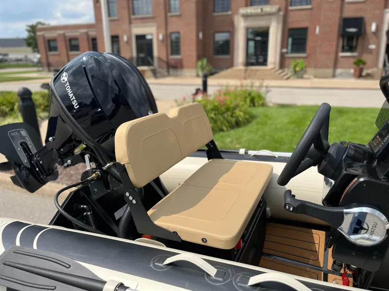 Slide: The Image of 2025 Highfield Classic 360 GT boat with Tohatsu engine, beige seating, and steering wheel. - 4