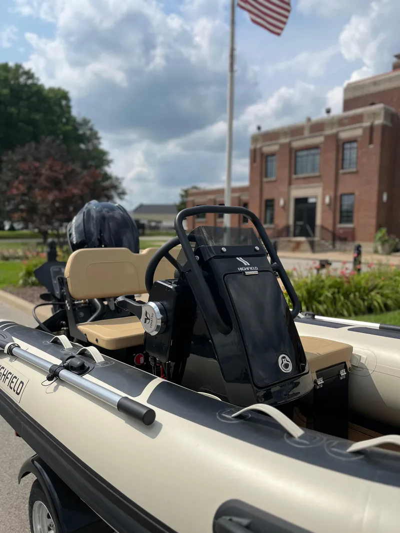 Slide: The Image of 2025 Highfield Classic 360 GT boat with modern design, parked near a brick building. - 5