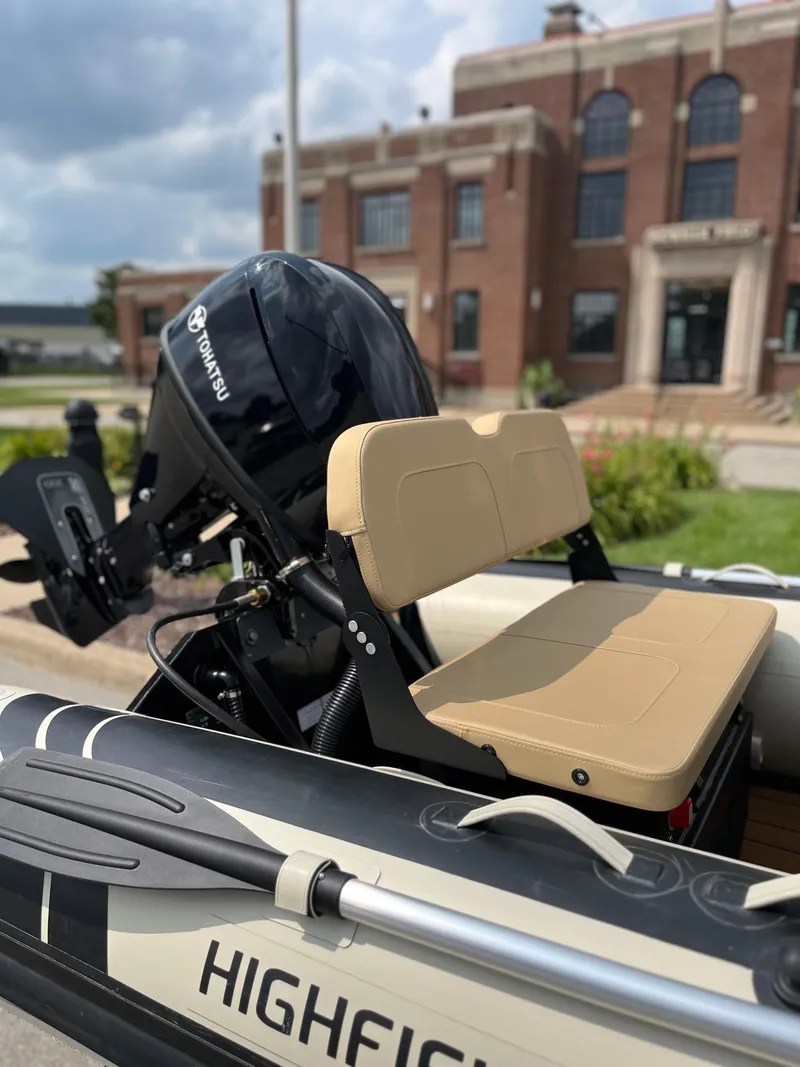 Slide: The Image of 2025 Highfield Classic 360 GT boat with Suzuki outboard motor, beige seating, and oars. - 7