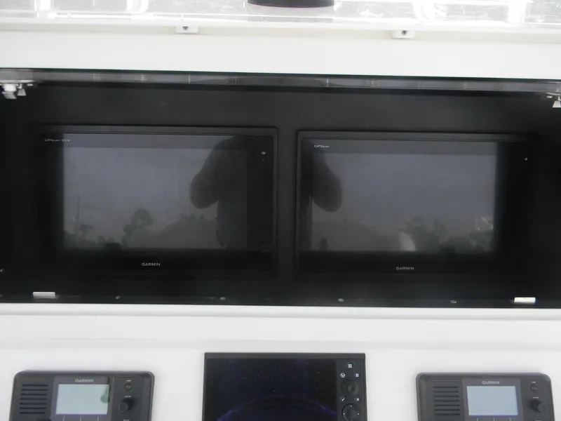 Slide: The Image of 2019 Contender 39 ST boat dashboard with dual Garmin displays and control panels. - 12