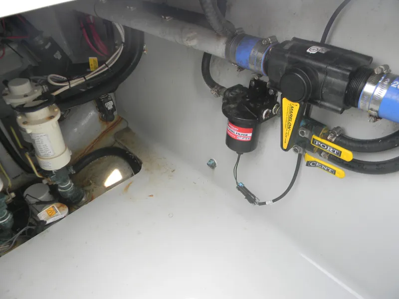 Slide: The Image of 2019 Contender 39 ST boat engine compartment with visible plumbing and wiring components. - 16