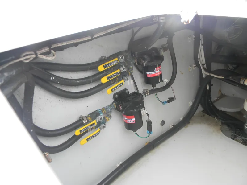 Slide: The Image of 2019 Contender 39 ST boat wiring and pump system in compartment. - 17