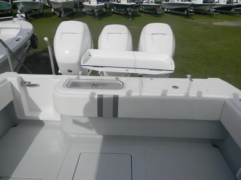 Slide: The Image of 2019 Contender 39 ST boat with triple outboard engines, featuring a spacious deck layout. - 3