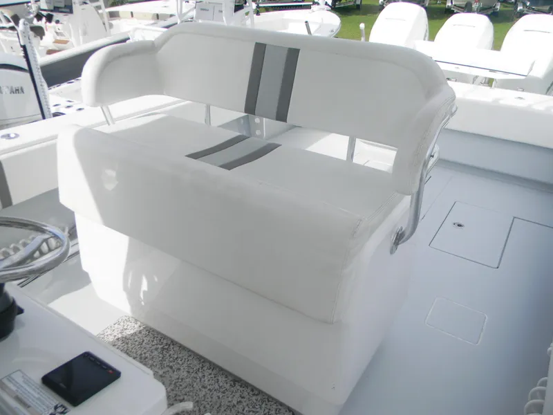 Slide: The Image of 2019 Contender 39 ST boat with white cushioned seating and sleek design. - 5