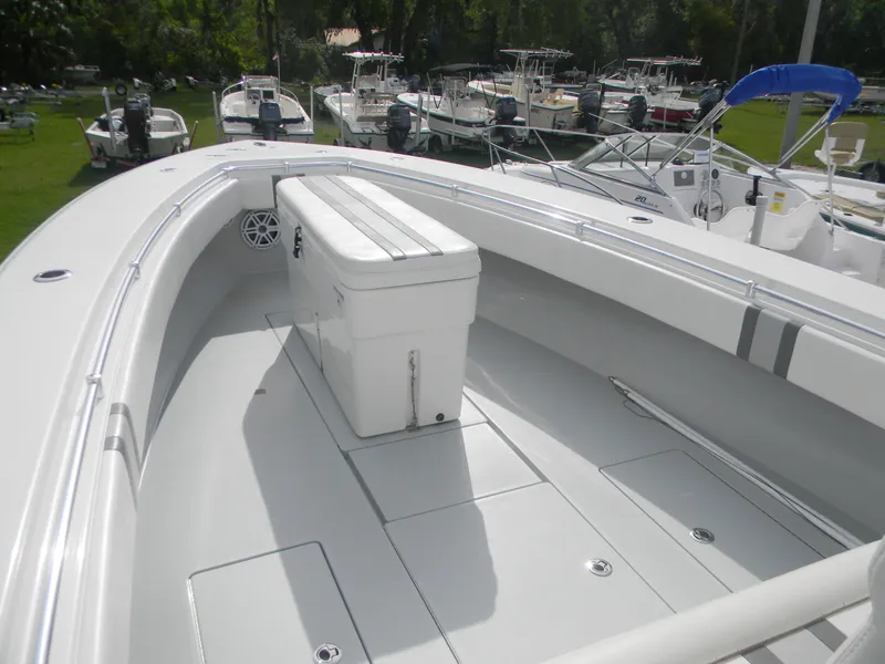 Slide: The Image of 2019 Contender 39 ST boat deck with seating and storage, docked among other boats. - 6