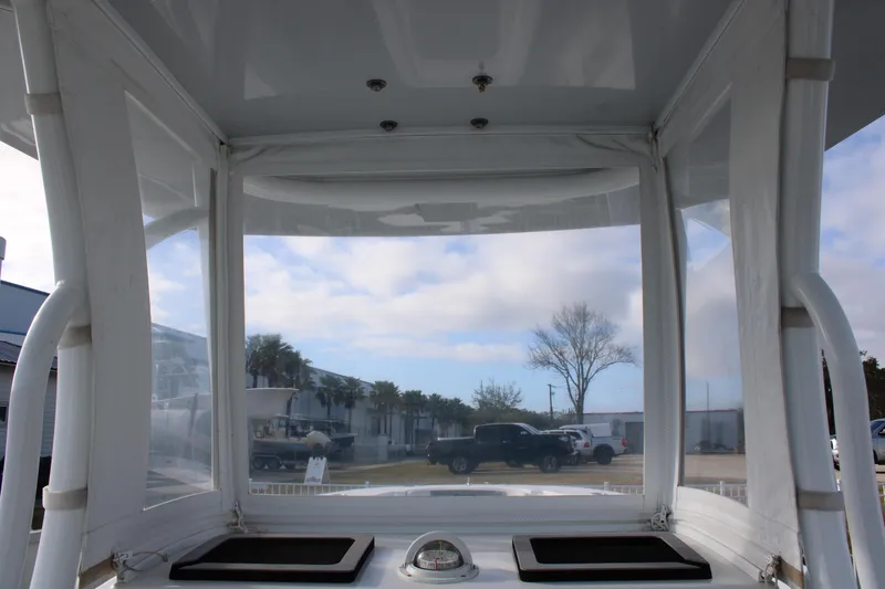 Slide: The Image of 2023 Front Runner 33 Center Console boat interior with clear canopy and outdoor view. - 22