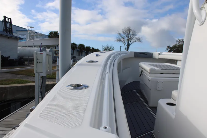 Slide: The Image of 2023 Front Runner 33 Center Console boat docked under a cloudy sky. - 25