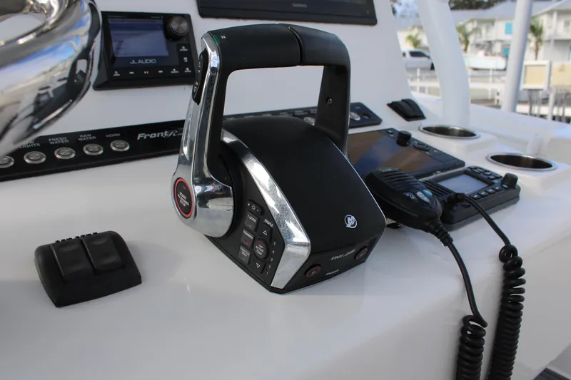 Slide: The Image of 2023 Front Runner 33 Center Console boat dashboard with controls and electronics. - 28
