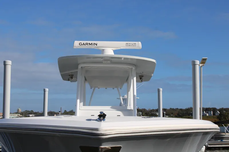 Slide: The Image of 2023 Front Runner 33 Center Console boat with Garmin radar, docked under blue sky. - 3