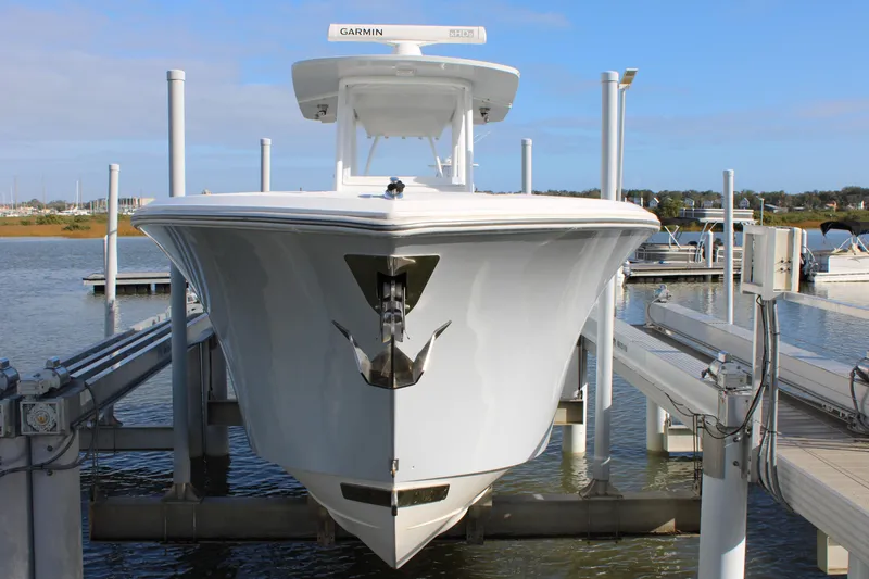 Slide: The Image of 2023 Front Runner 33 Center Console boat on lift at marina. - 4