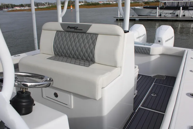 Slide: The Image of 2023 Front Runner 33 Center Console boat with cushioned seating and dual Mercury engines. - 42