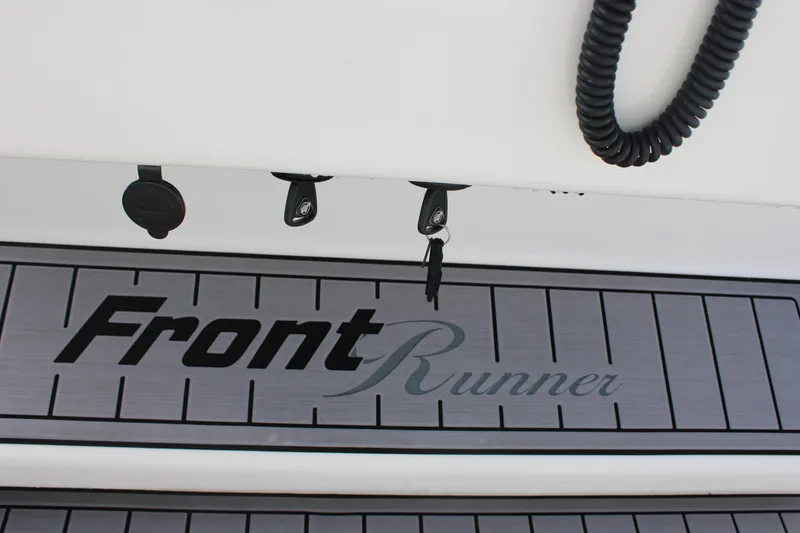 Slide: The Image of 2023 Front Runner 33 Center Console boat deck with logo and accessories. - 6