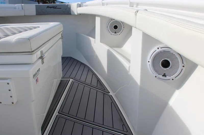 Slide: The Image of 2023 Front Runner 33 Center Console boat interior with speakers and cushioned seating. - 7