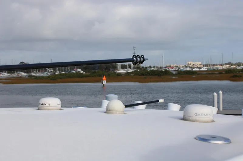 Slide: The Image of 2023 Front Runner 33 Center Console boat with Garmin equipment, docked near a marina. - 9