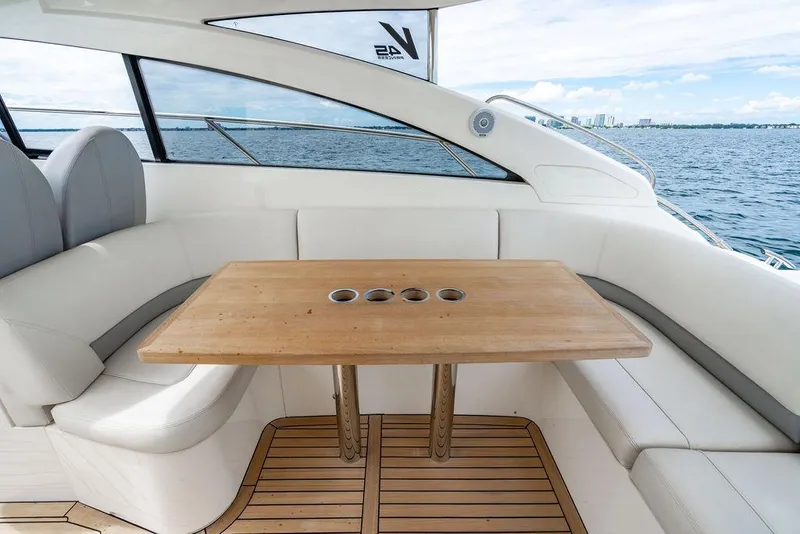 Slide: The Image of Luxurious 2012 Princess V45 yacht interior with wooden table and white seating. - 16