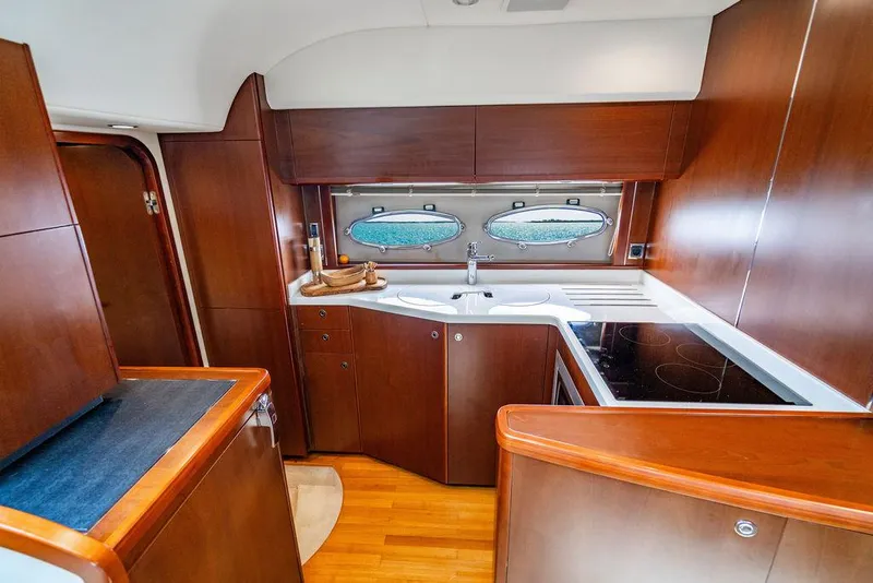 Slide: The Image of Luxurious 2012 Princess V45 yacht kitchen with wood cabinetry and modern appliances. - 25