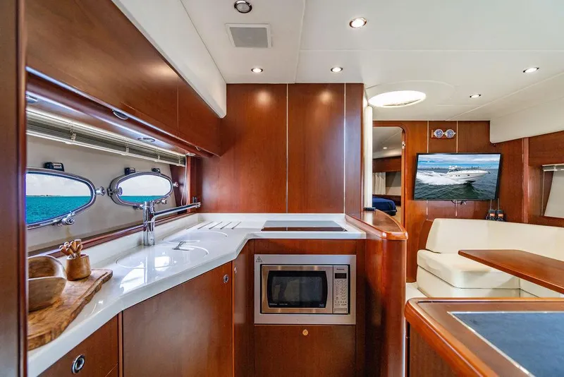 Slide: The Image of Luxurious interior of 2012 Princess V45 yacht with modern kitchen and seating area. - 26