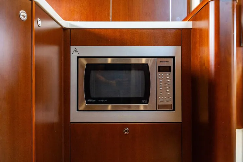 Slide: The Image of Microwave in 2012 Princess V45 yacht kitchen with wooden cabinetry. - 27