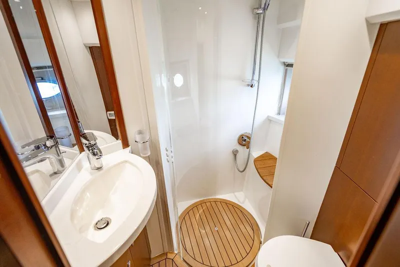 Slide: The Image of Luxurious bathroom in 2012 Princess V45 yacht with modern fixtures and wooden accents. - 32